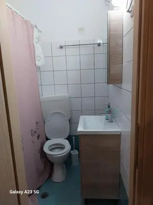 a small bathroom with a toilet and a sink at Poseidon Studios Chania Center in Chania Town