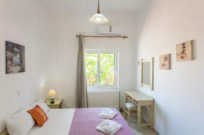 a bedroom with a bed and a window at Despina Villa in Agia Marina Nea Kydonias
