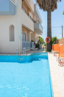a swimming pool in front of a villa at Despina Villa in Agia Marina Nea Kydonias