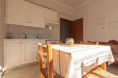 a kitchen with a table with a white table cloth at Virginia Studios in Palaiochóra