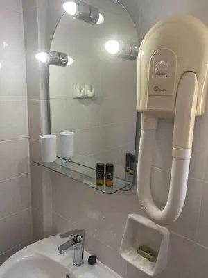 a bathroom with a sink and a mirror at Virginia Studios in Palaiochóra