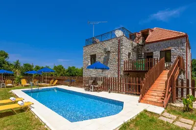 a house with a swimming pool in front of it at Charming Villa in Gerani Chanion