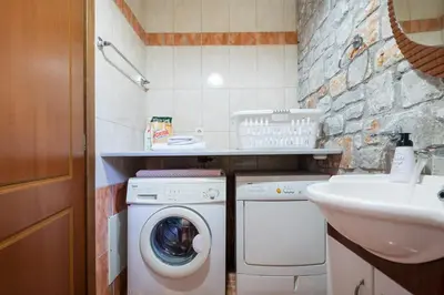 a small bathroom with a washing machine and a sink at Charming Villa in Gerani Chanion
