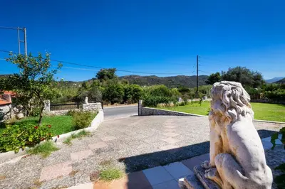 a statue of a woman sitting on a road at Charming Villa in Gerani Chanion