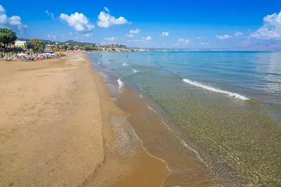 a beach with a lot of people in the water at Charming Villa in Gerani Chanion