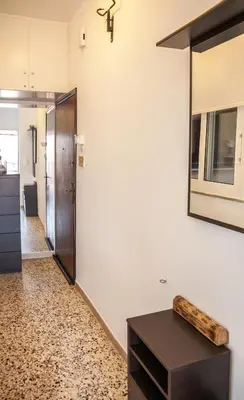 a hallway with a mirror and a table at Rafaellas Apartment in Chania Town