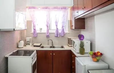 a small kitchen with a sink and a window at Rafaellas Apartment in Chania Town