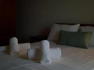 a bed with two rolls of towels on it at Panos Village in Maláxa