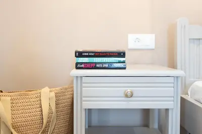 a stack of books sitting on top of a table at Romeos Studios in Agia Marina Nea Kydonias