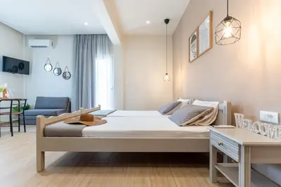 a bedroom with a large bed in a room at Romeos Studios in Agia Marina Nea Kydonias