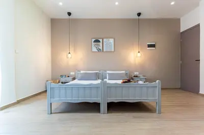 a bedroom with two beds and two lights at Romeos Studios in Agia Marina Nea Kydonias
