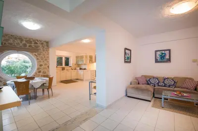 a living room with a couch and a table at Villa Asteri in Kalamaki Chanion
