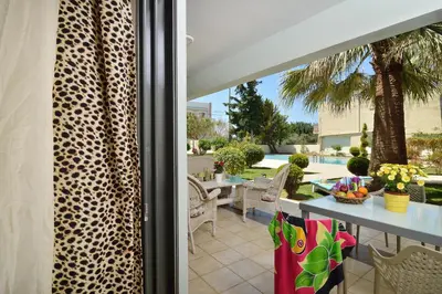 a patio with a table and chairs on a patio at Alexandra's Relaxing Suite in Kalamaki Chanion