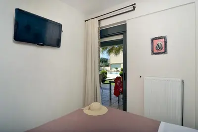 a hat sitting on a table in a room with a television at Alexandra's Relaxing Suite in Kalamaki Chanion