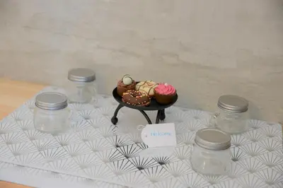 a table with a plate of cupcakes and jars on it at Iconic Chania in Chania Town