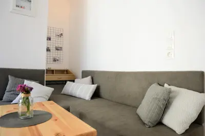 a living room with a couch and a table at Iconic Chania in Chania Town
