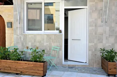 a white door on a house with two plants at Iconic Chania in Chania Town