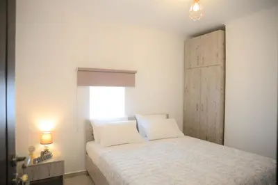 a bedroom with a white bed and a window at Iconic Chania in Chania Town