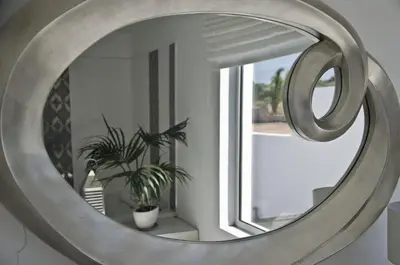 a mirror in a room with a plant and a window at Reveli Estate in Kalathas