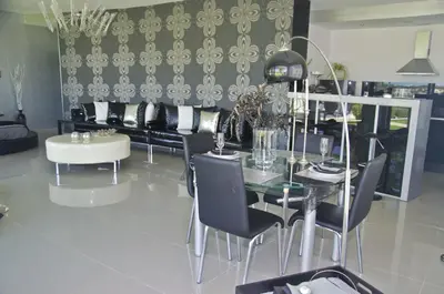 a dining room with a table and chairs and a couch at Reveli Estate in Kalathas