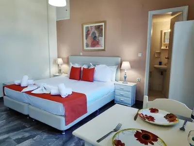 a hotel room with a bed and a table with a tableasonable at Creta Sun Studios in Kato Daratso