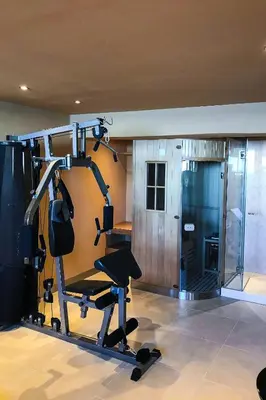 a room with a gym with a tread machine at Athina Epavlis - Ethereal Charm of Blue Horizons in Ravdhoúkha