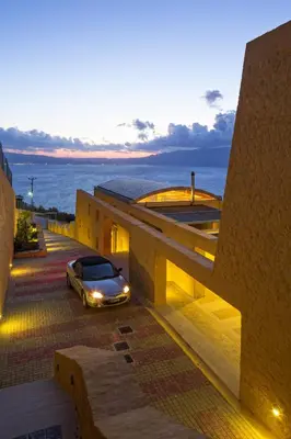 a car parked on the side of a building at Athina Epavlis - Ethereal Charm of Blue Horizons in Ravdhoúkha