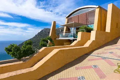 a house with a view of the ocean at Athina Epavlis - Ethereal Charm of Blue Horizons in Ravdhoúkha