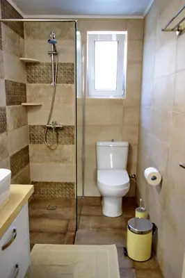 a bathroom with a toilet and a glass shower at casa Marilia in Chania Town