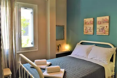 a bedroom with a bed and a window at casa Marilia in Chania Town