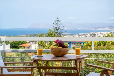 a bowl of fruit on a table on a balcony at Casa Chrysa Chania 1st floor house with amazing view in Galatás
