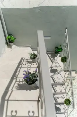 a set of stairs with potted plants on them at Casa Chrysa Chania 1st floor house with amazing view in Galatás