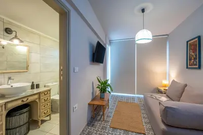 a living room with a couch and a sink at Casa Chrysa Chania 1st floor house with amazing view in Galatás