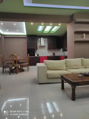 a living room with a couch and a table at Homieland Souda in Souda
