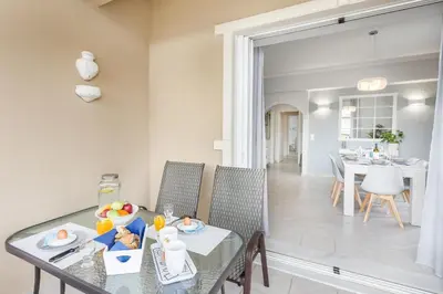 a dining room and kitchen with a table and chairs at Marika's Guest House Chania in Chania Town