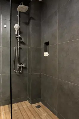a shower with a glass door in a bathroom at NV Illusion in Chania Town
