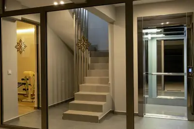 a staircase in a house with a glass door at NV Illusion in Chania Town