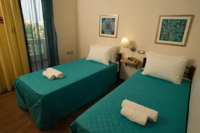 a hotel room with two beds with towels on them at Villa Anthira in Ropanianá