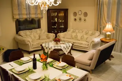 a living room with couches and a table and chairs at Villa Anthira in Ropanianá