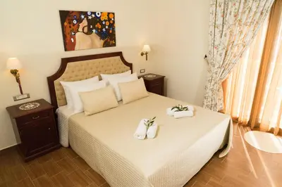 a bedroom with a bed with two towels on it at Villa Anthira in Ropanianá