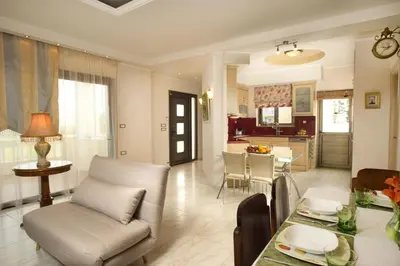 a living room and kitchen with a couch and a table at Villa Anthira in Ropanianá