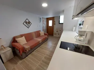 a living room with a couch in a kitchen at Evans House II One Bedroom Maisonette in Chania Town