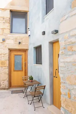 a patio with a table and chairs in front of a building at Evans House II One Bedroom Maisonette in Chania Town