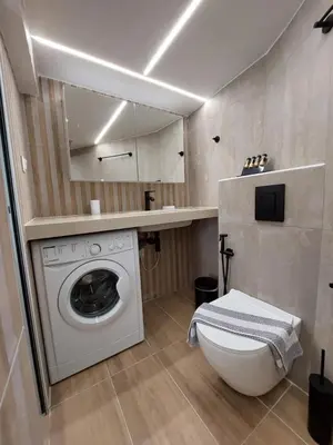 a bathroom with a washing machine and a toilet at Evans House II One Bedroom Maisonette in Chania Town