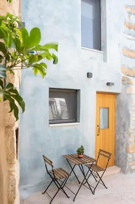 a table and chairs in front of a building at Evans House II One Bedroom Maisonette in Chania Town