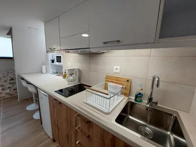 a kitchen with a sink and a stainless steel sink at Evans House II One Bedroom Maisonette in Chania Town