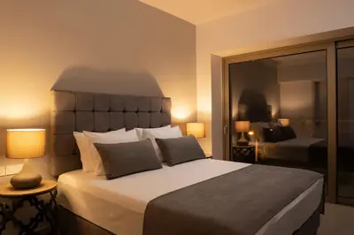 a bedroom with a large bed and a large mirror at NV Two in Chania Town