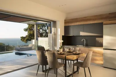 a kitchen and dining room with a table and chairs at NV Two in Chania Town
