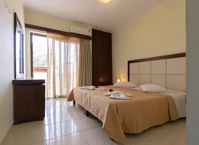a bedroom with a large bed with towels on it at Sandy Suites in Kalamaki Chanion