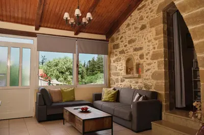 a living room with a couch and a table at Batilas Garden House in Kissamos